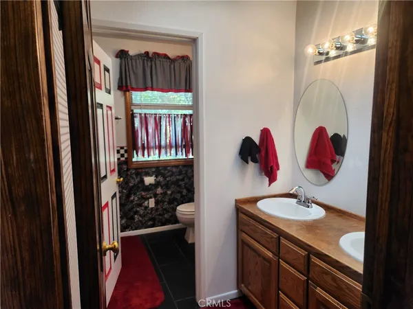 a bathroom with a toilet a sink and a shower curtain