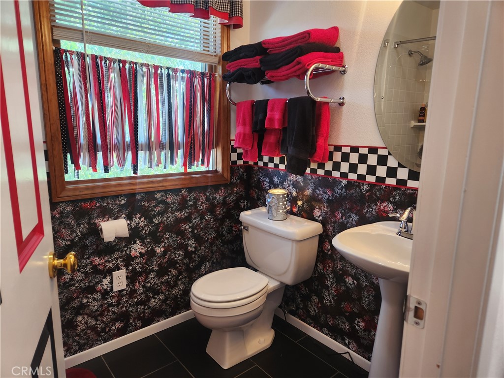 1014 Dusty Road Frazier Park, CA 93225 - Photo 33 of 40 a bathroom with a toilet a sink and a shower curtain