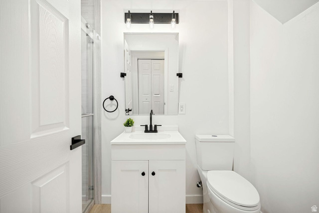 1723 Albury Road Sandy, UT 84092 - Photo 21 of 23 Contemporary bathroom featuring beautiful shower, a white vanity with integrated sink, matte black faucet, and coordinating hardware