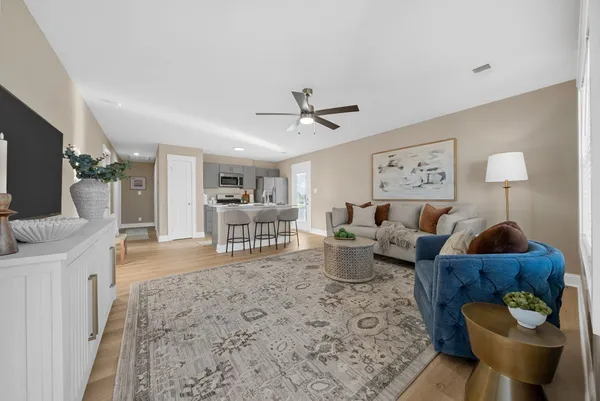 a living room with furniture and a flat screen tv
