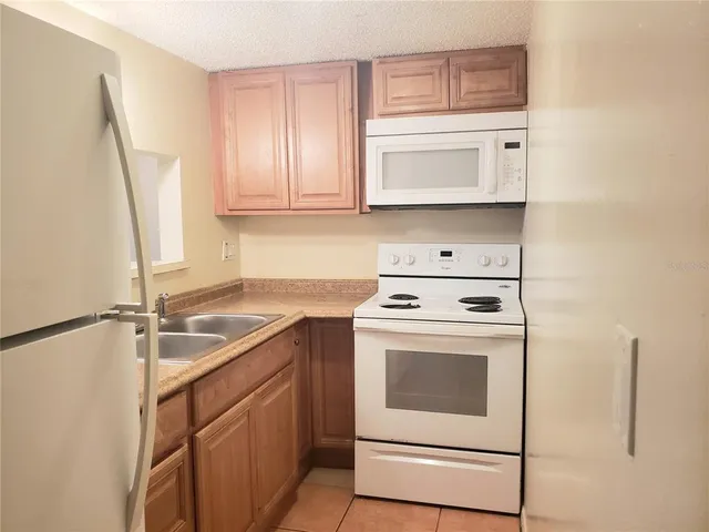 a kitchen with a sink a stove and cabinets