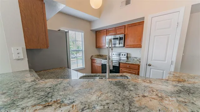 a kitchen with stainless steel appliances granite countertop a stove and a refrigerator