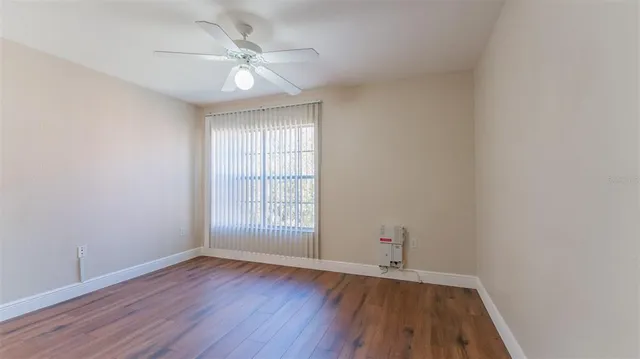 a view of hallway with bathroom and wooden floor