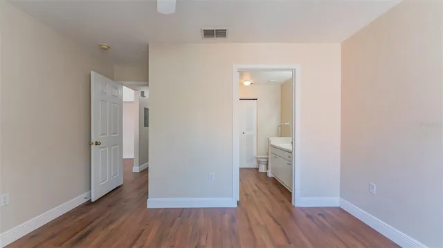a view of a hallway with wooden floor