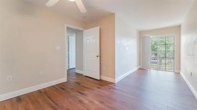 a view of a hallway with wooden floor