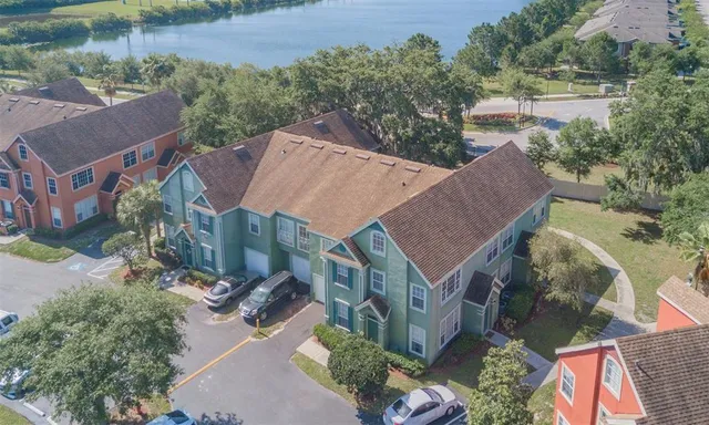 an aerial view of a city with lots of residential buildings lake and ocean view