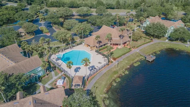 an aerial view of a house with a yard