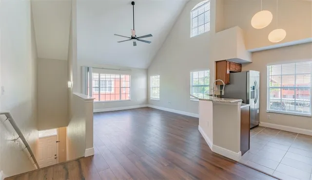 a view of a kitchen with furniture wooden floor and window