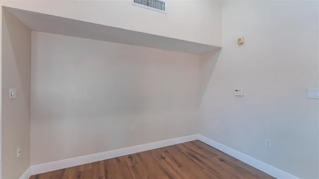 a view of a kitchen cabinets and wooden floor