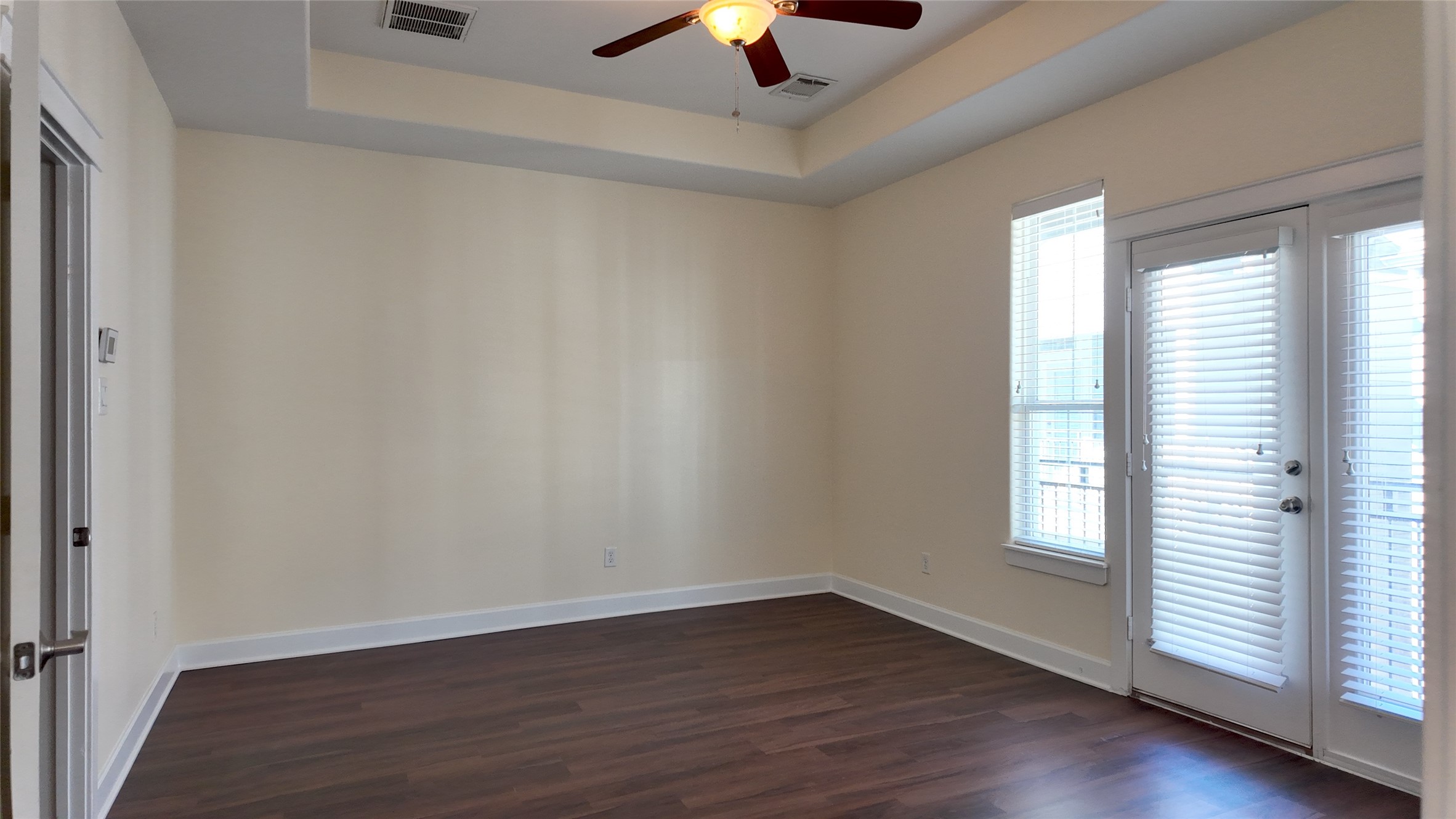 902 West 20th Street, Unit B Houston, TX 77008 - Photo 8 of 15 an empty room with wooden floor chandelier fan and windows