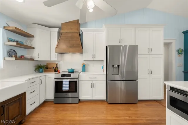 a kitchen with stainless steel appliances a refrigerator sink and cabinets