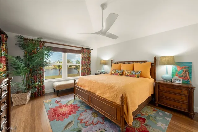 a bedroom with bed and large windows