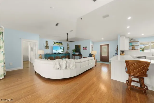 a living room with furniture and kitchen view