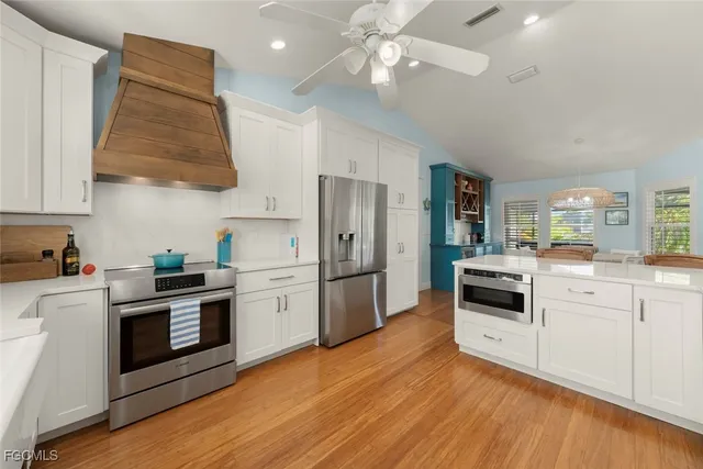 a kitchen with stainless steel appliances a stove a sink and a refrigerator