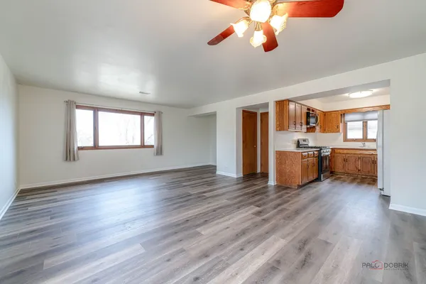 a view of a kitchen with furniture wooden floor and windows