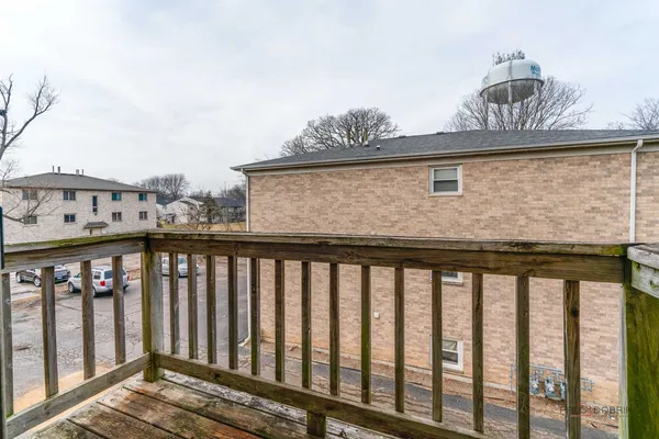 a view of a balcony with wooden fence