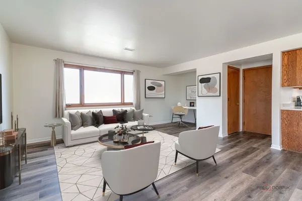 a living room with furniture window and wooden floor