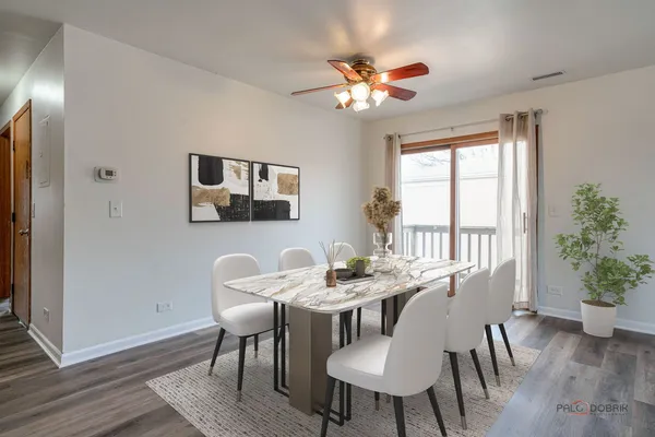 a view of a dining room with furniture window and wooden floor