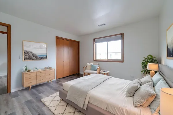 a bedroom with a bed and a dresser