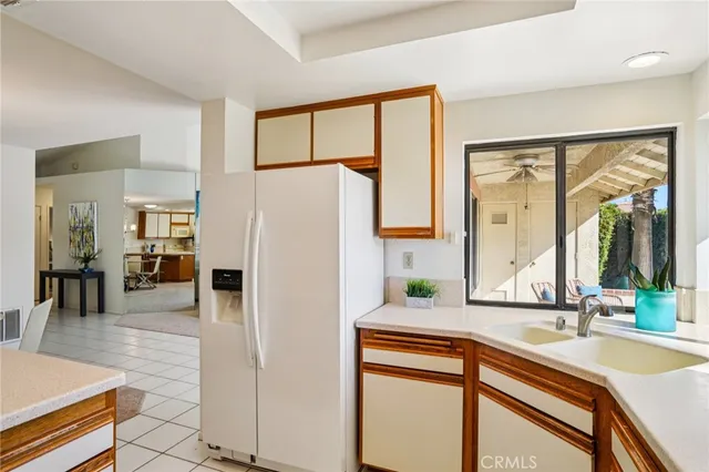 a kitchen with a refrigerator and a sink