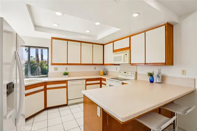 a kitchen with a sink a stove and cabinets
