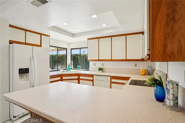 a kitchen with stainless steel appliances a sink and a refrigerator