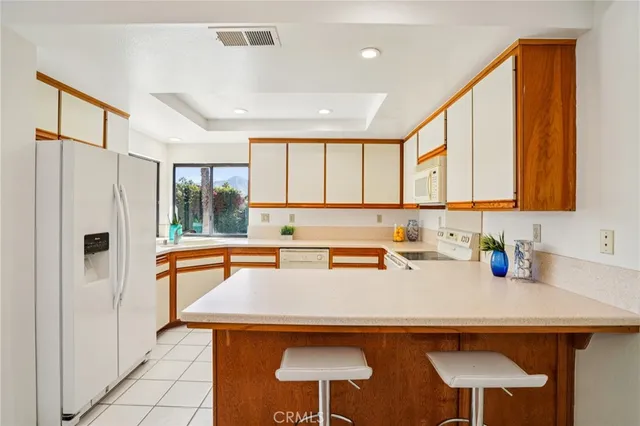 a kitchen with stainless steel appliances a sink and a refrigerator