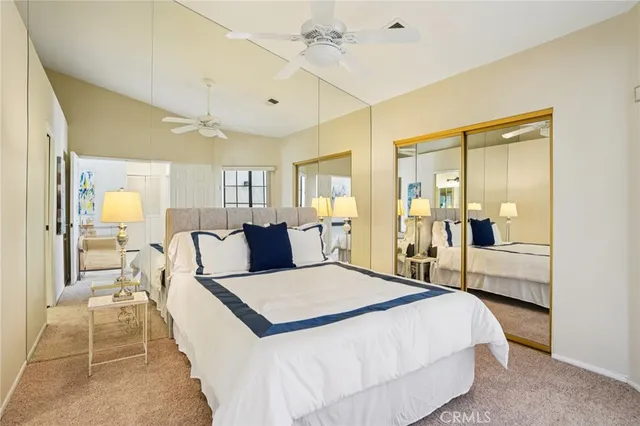 a large bedroom with a bed and a view of bathroom