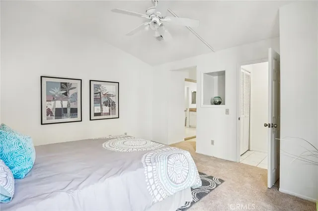a spacious bedroom with a bed and a chandelier