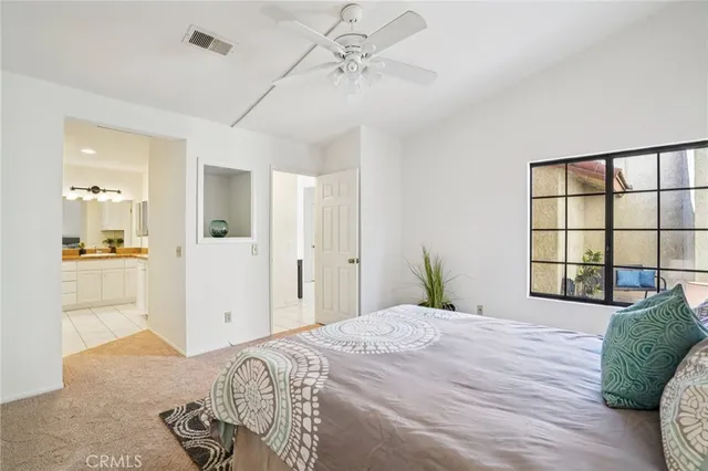 a bedroom with a large bed and a window