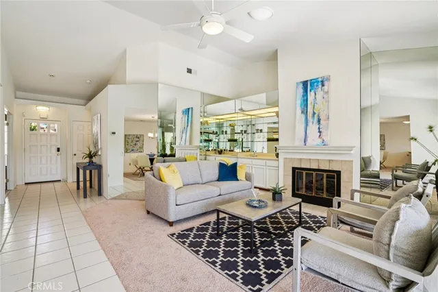 a living room with furniture a fireplace and a chandelier