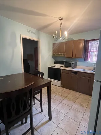 a kitchen with kitchen island granite countertop a sink counter top space cabinets and stainless steel appliances