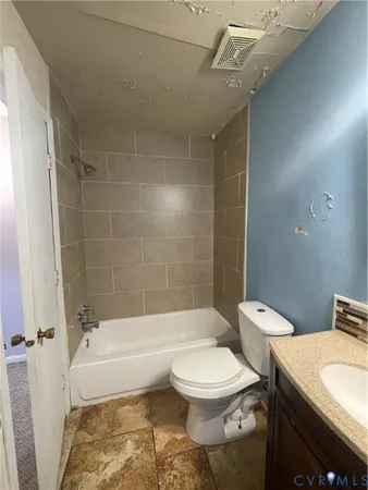 a bathroom with a toilet a sink and bathtub