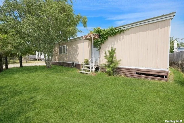a backyard of a house with table and chairs