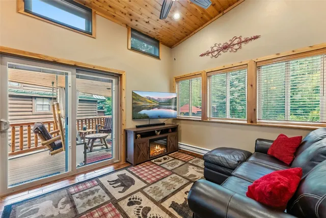 a living room with furniture and large windows