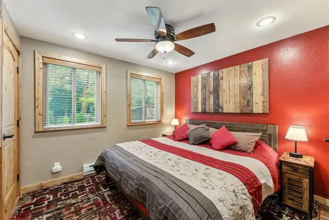 a bedroom with a bed and a large window