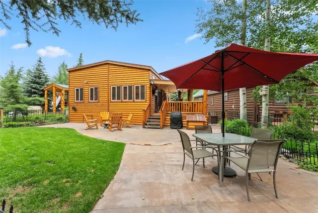 a view of a house with backyard and sitting area