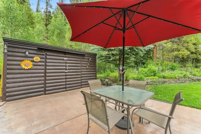 a backyard view of a house with garden and patio