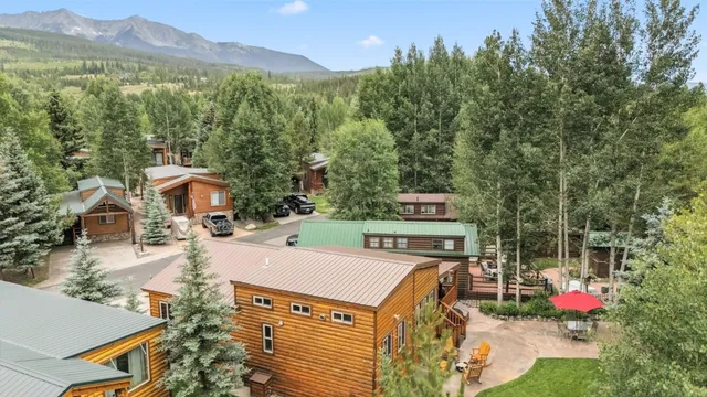 an aerial view of a house with yard garden and mountain view in back