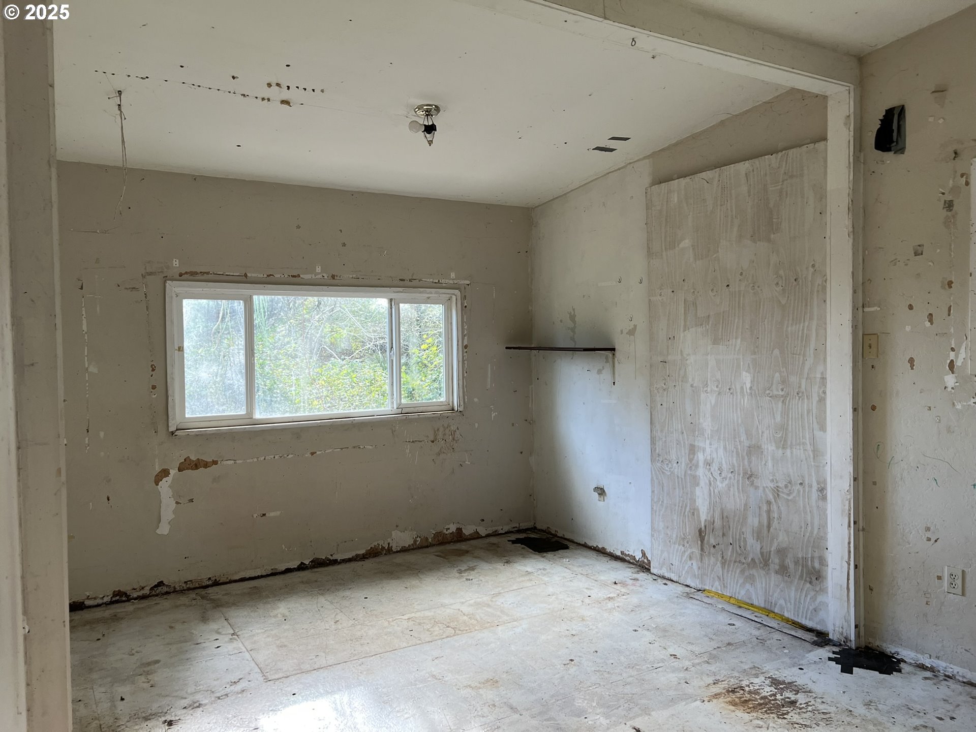 1032 Marina Heights Road Brookings, OR 97415 - Photo 41 of 43 a view of an empty room with a window