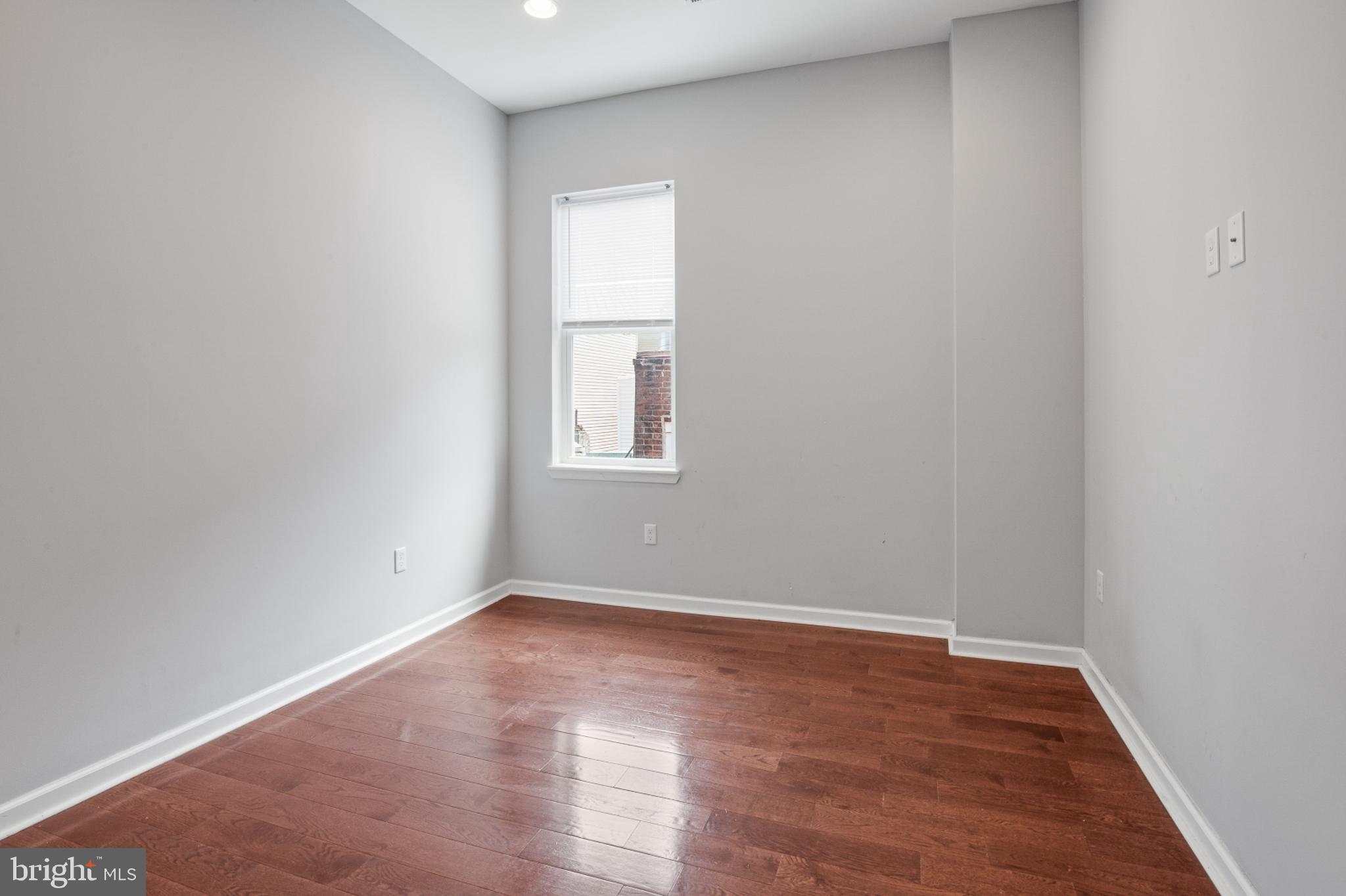 511 South Street, Unit 2 Philadelphia, PA 19147 - Photo 4 of 24 an empty room with wooden floor and windows