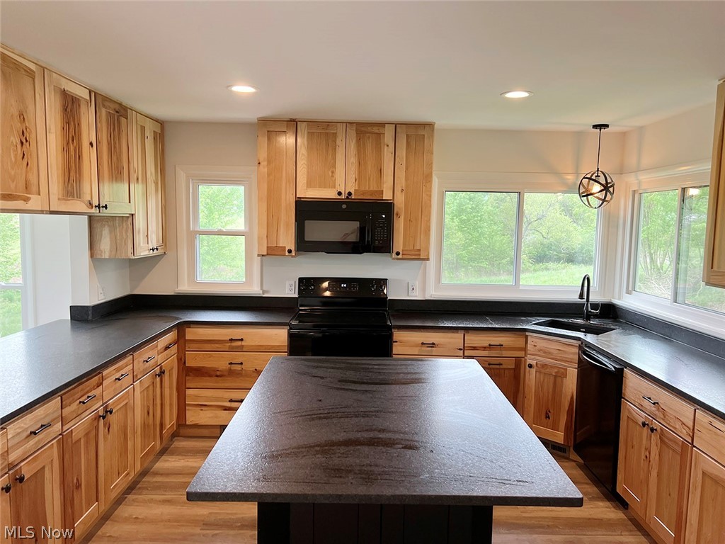 550 Johnson Road Wadsworth, OH 44281 - Photo 5 of 40 Kitchen with sink, light hardwood / wood-style flooring, a center island, and black appliances