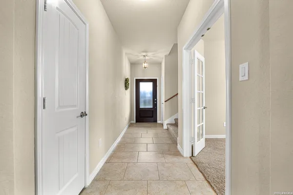 a view of a hallway with wooden shelves