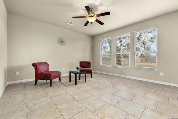 a living room with furniture and a ceiling fan