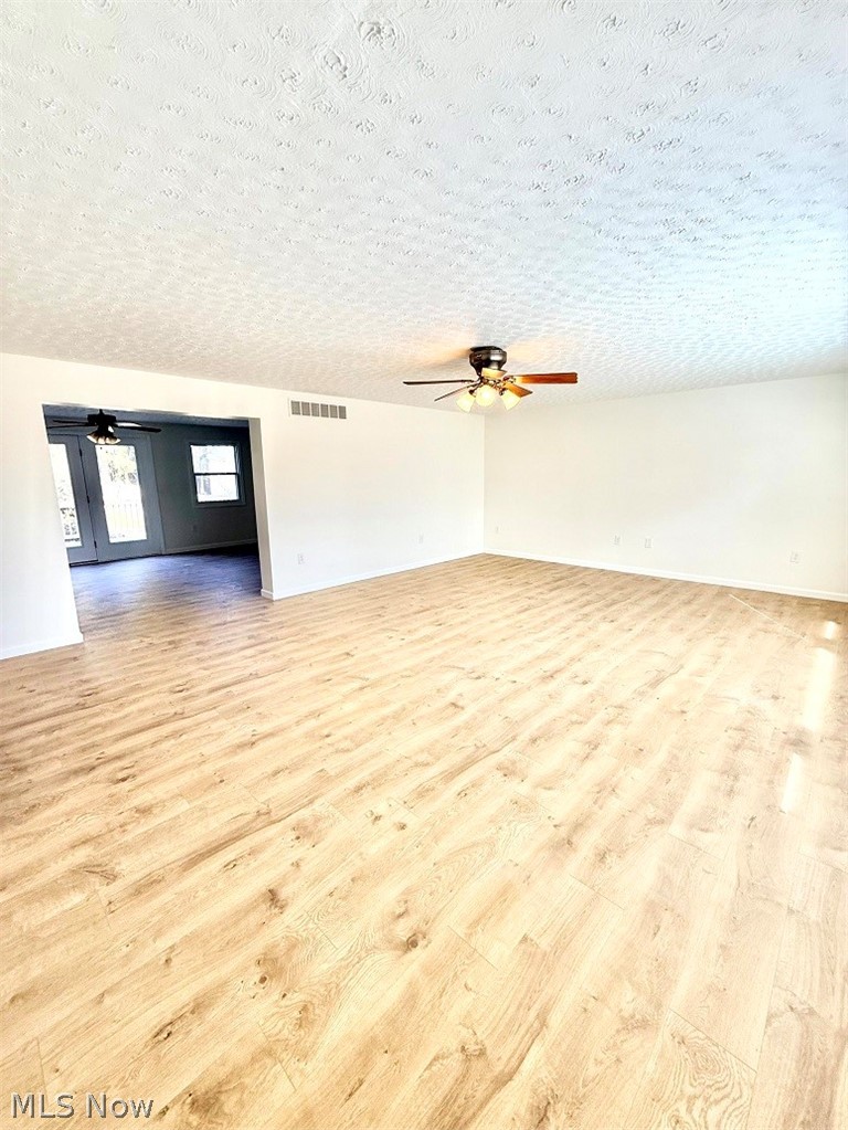 144 Aberdeen Road Steubenville, OH 43953 - Photo 9 of 34 Spare room with ceiling fan, light wood-style flooring, and a textured ceiling
