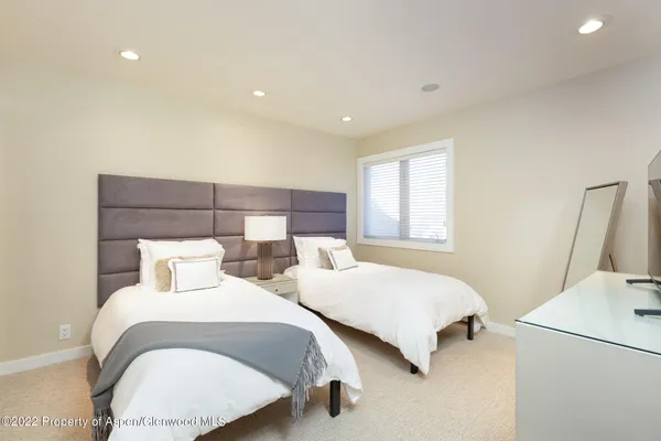 a bedroom with two beds and a window
