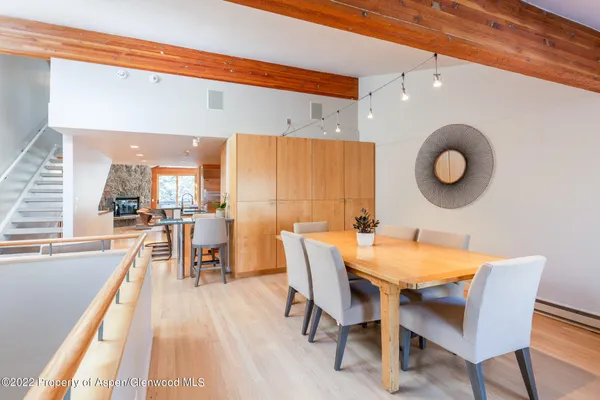 a view of a dining room with furniture and wooden floor