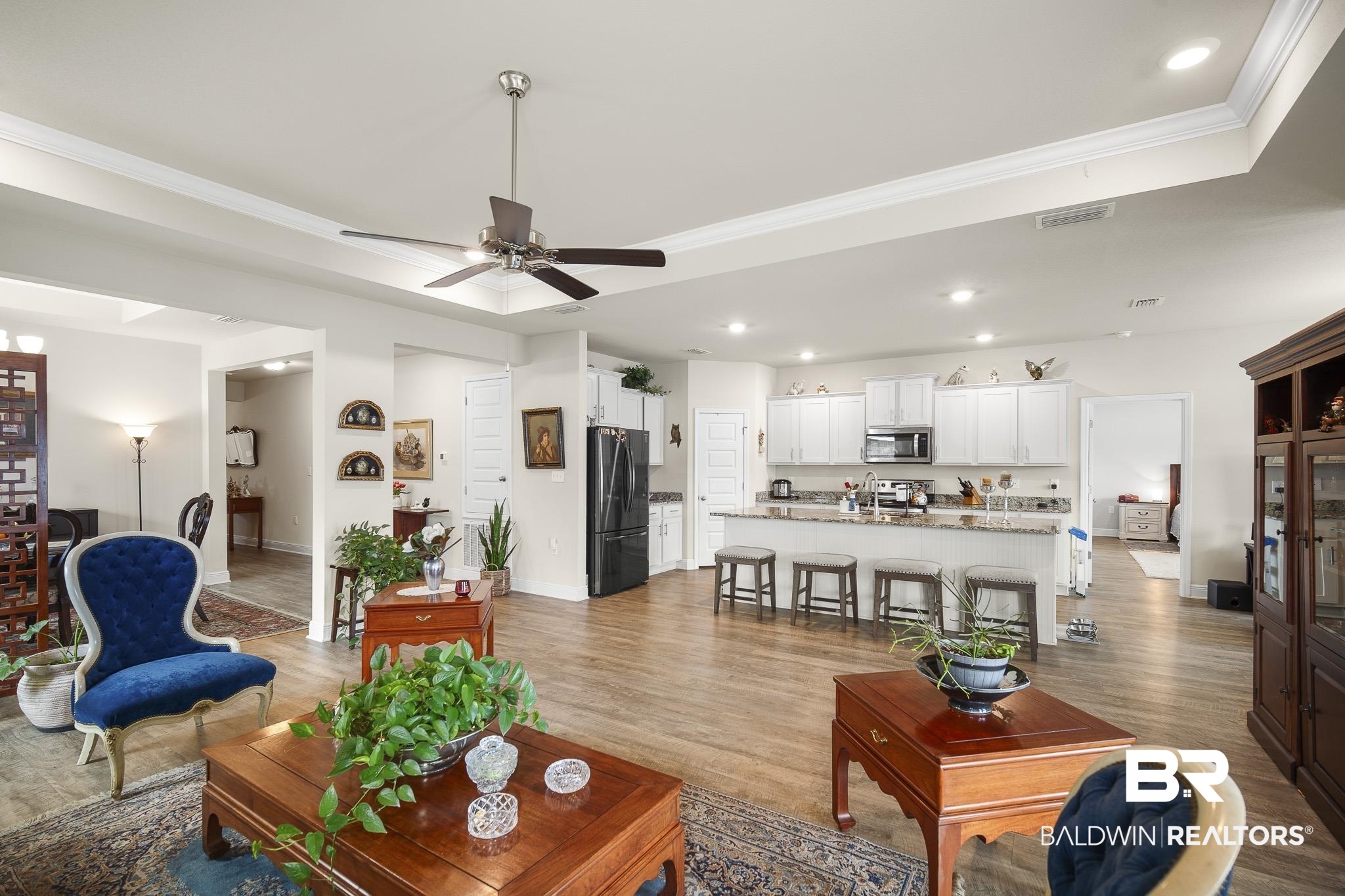 24765 Spectacular Bid Loop Daphne, AL 36526 - Photo 13 of 45 Living room featuring wood-type flooring, ceiling fan, crown molding, and a tray ceiling