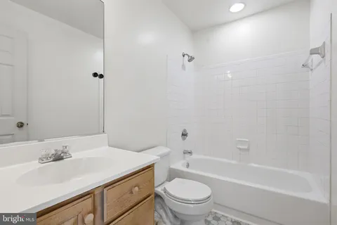 a bathroom with a sink toilet vanity and bathtub