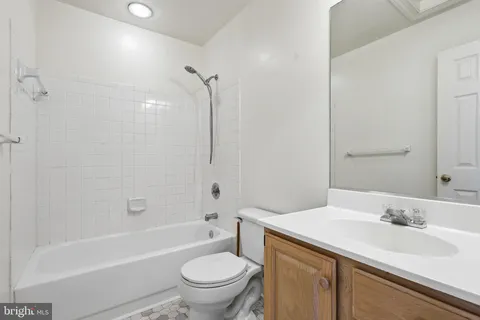 a bathroom with a sink toilet vanity and shower